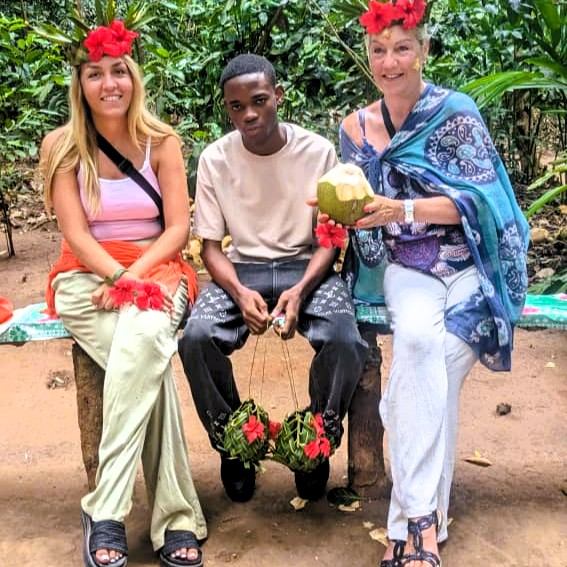 Guests and guide smiling among tropical plants